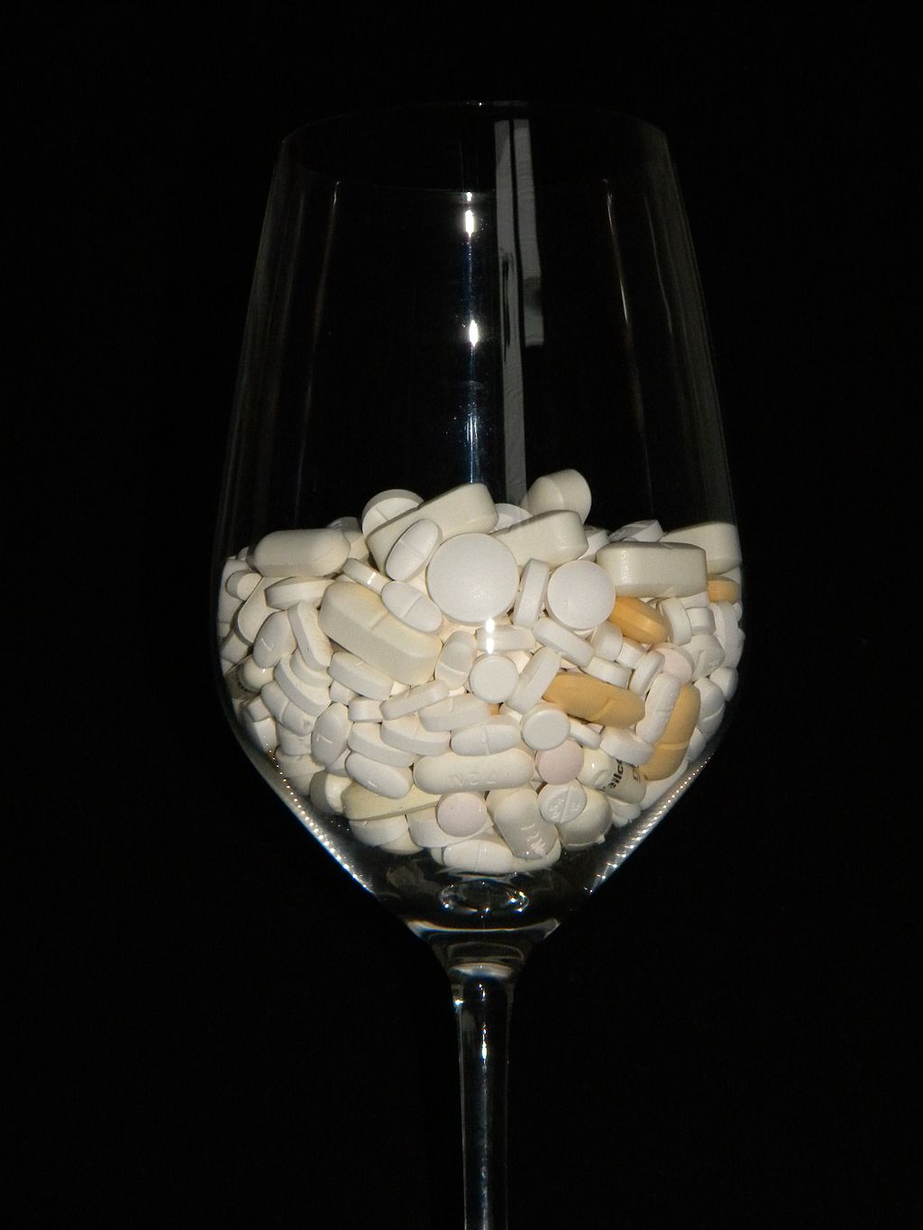Medicine cocktail tablets and pills in glass